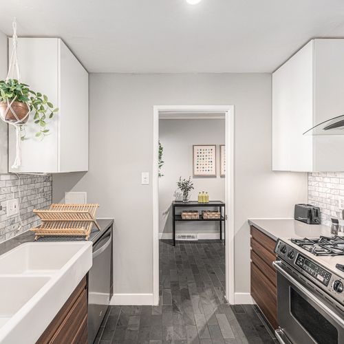 Cook in style in this beautiful galley kitchen, featuring sleek stainless steel appliances and plenty of counter space.