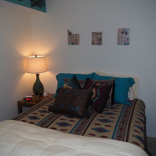 Bedroom:  very comfortable bedroom with a queen-size bed, ceiling fan, dresser, and mirror.