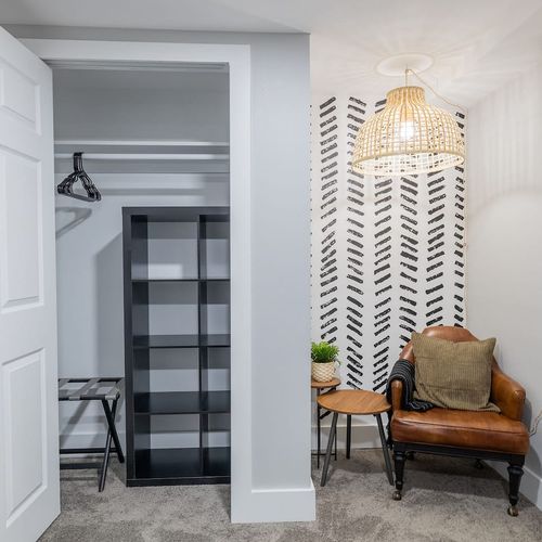 - keep things tidy with open shelving, hangers, and a foldable luggage rack for convenience
- cozy leather chair under a woven pendant light, perfect for a quiet moment
- bold accent wall and layered textures create a fresh, designer inspired corner