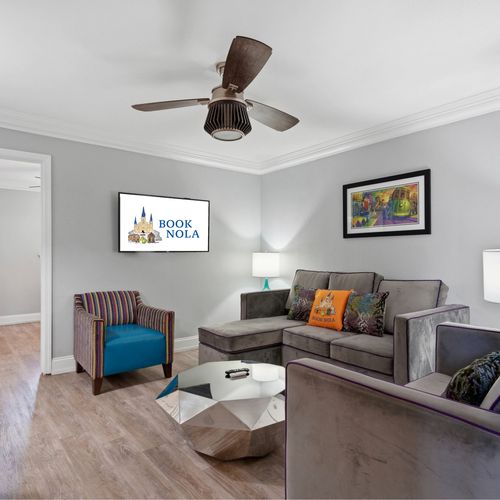 Bright living room w/ comfy seating & ceiling fan to kick back