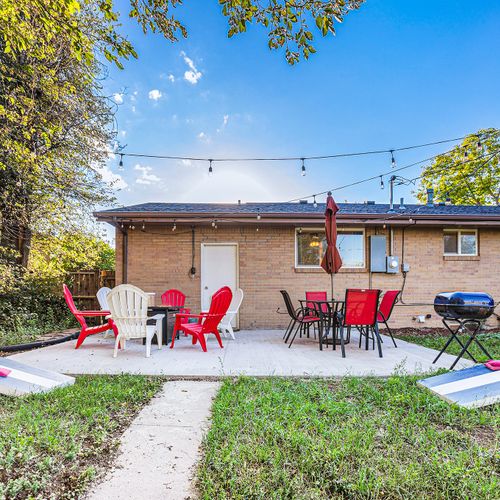 Dine and relax on our newly updated backyard patio, perfect for any occasion. Cozy up in adirondack seats or enjoy a group meal al fresco on the dining set with a shaded umbrella.