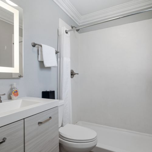 Clean, bright bathroom w/ modern fixtures & plenty of counter space.