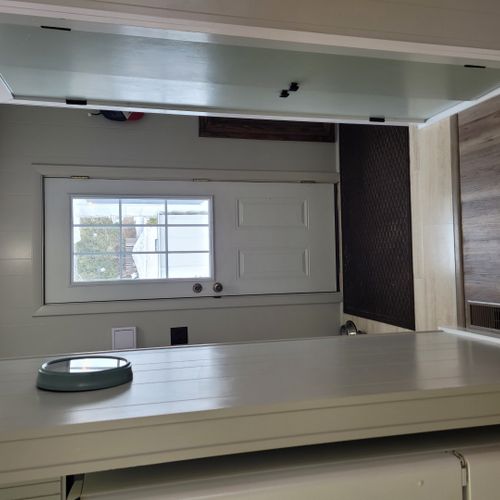 Bathroom #2:  cute little half-bathroom with toilet, sink, vanity, and mirror located near the rear door out to the deck.