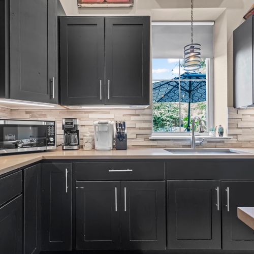 Fully stocked kitchen framed by garden views.