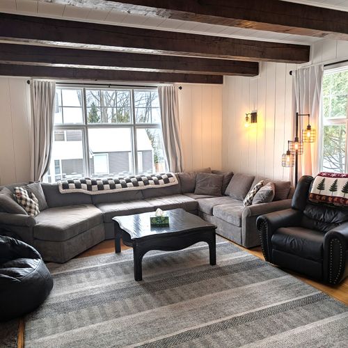 LIVING ROOM (MAIN FLOOR):  Gorgeous main floor living room with a large live streaming television, gas fireplace, and lots of seating!