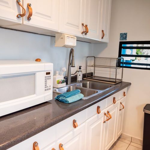 Enjoy the convenience of a dedicated kitchen workstation, complete with a microwave and all the essentials for cooking and tidying up after your culinary adventures.