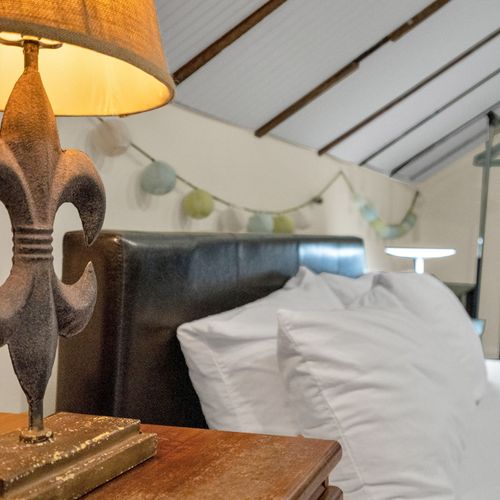 Plush bed w/ soft linens & elegant headboard for a truly restful night.