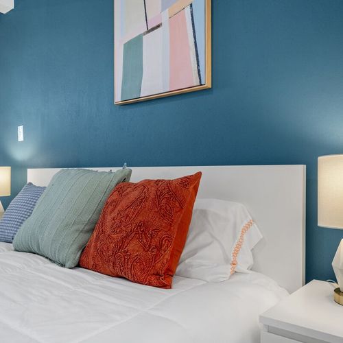 Enhanced by captivating contemporary artwork and a vibrant accent wall that brings life to the room.
