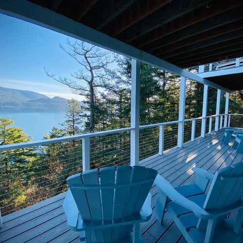 Lower deck and seating for both guest bedrooms on the lower level.   Views of East Sound and Crescent Beach for those quiet mornings..