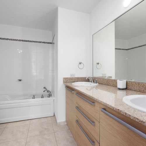 Luxurious bathroom with dual sinks and elegant stone countertops.