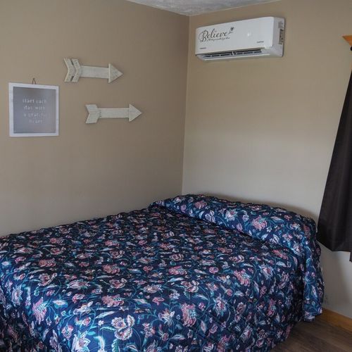 Main room:  another angle, showing the full-size bed and the combination heater and air conditioner.