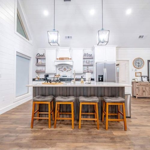 4 seats at the island in the kitchen.