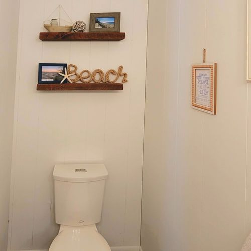 Half-bath:  conveniently entered into from the living room, there is a common half-bath with a sink, vanity, mirror, and toilet.
