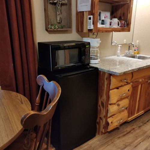 Main room:  features a small dining table with chairs, kitchenette  / sink, one twin-on-full bunk bed, and one twin-on-twin bunk bed.