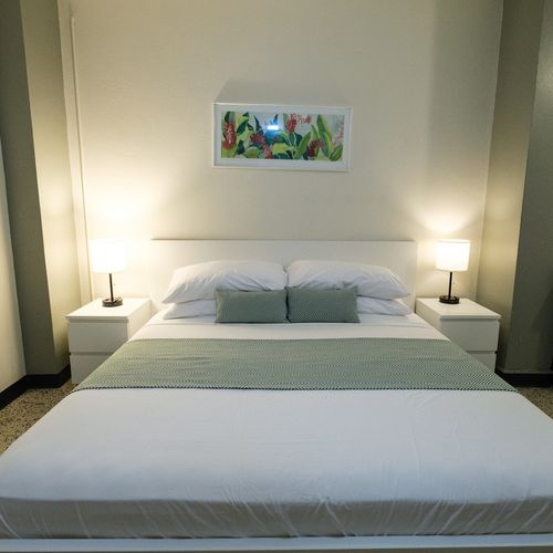 Experience peaceful sleep in our meticulously prepared bedroom, featuring a comfortable bed with fresh linens and soft lighting for a truly restful stay.