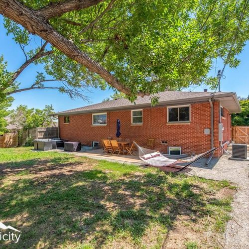 - spacious fenced backyard with mature trees and open grassy areas for play
- relax in the hammock or dine at the shaded patio set under the umbrella
- red brick exterior adds charm to this private outdoor escape