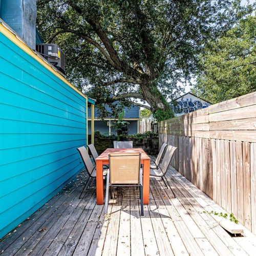 Shaded outdoor patio w/ seating for six — ideal for morning coffee or evening hangs.