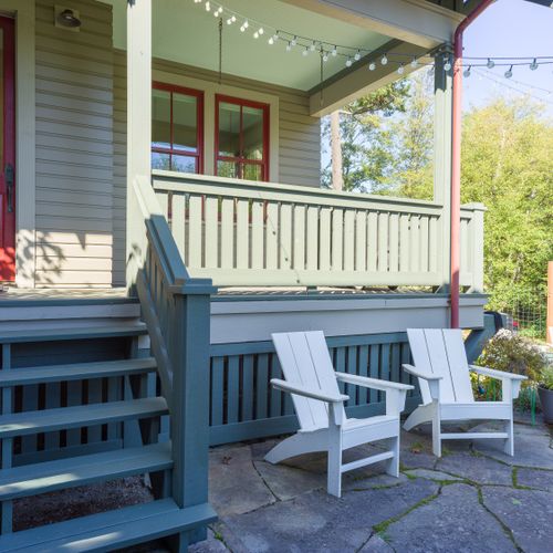 Cozy front porch with string lights and outdoor seating.