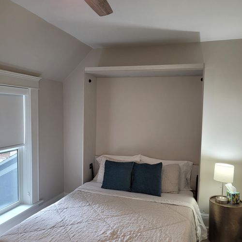 Bedroom #3 (second floor):  features a queen-size murphy bed, window a/c unit, ceiling fan, desk with chair, comfy chair, and a closet.