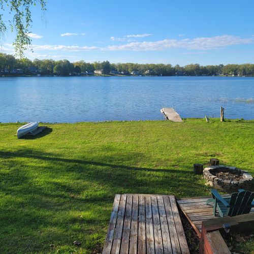 Overall:  backyard view of bass lake showcasing the fireplace and canoe