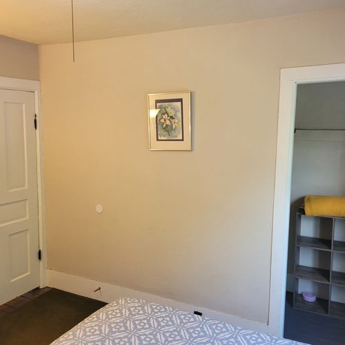 BEDROOM #1 (SECOND FLOOR):  Features a queen-size bed, baby crib, and closet.