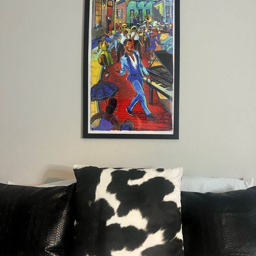 Vibrant local artwork sets the mood in this stylishly decorated bedroom.