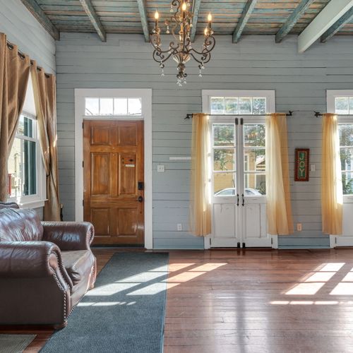 Sun-drenched entry w/ classic wood accents & a warm, welcoming vibe.