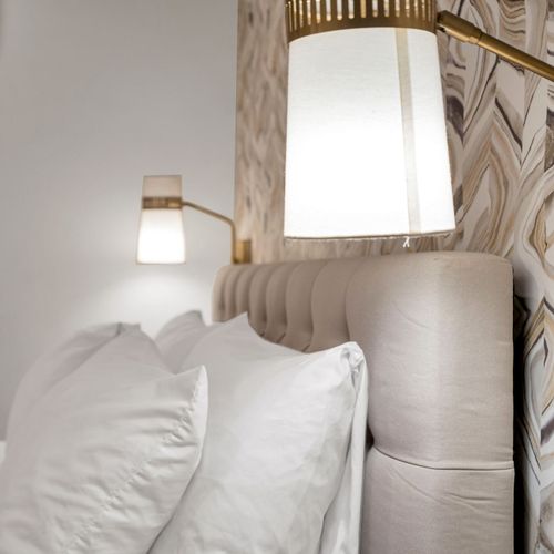 Plush pillows & warm bedside light set the tone for a good night's sleep.