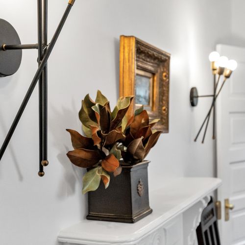 Decorative console w/ a mirror & artful accents that add personality to the space.