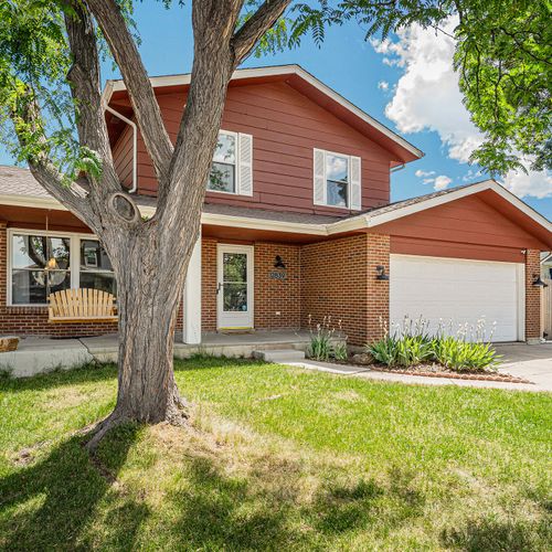 The front exterior of the house features a charming porch swing, evoking a sense of cozy comfort and inviting relaxation amidst the welcoming facade.