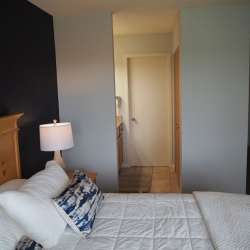 Master bedroom:  features a king-size bed, comfy chair, private balcony, nightstands with lamps, closet, its own television, and a private full en-suite bathroom!