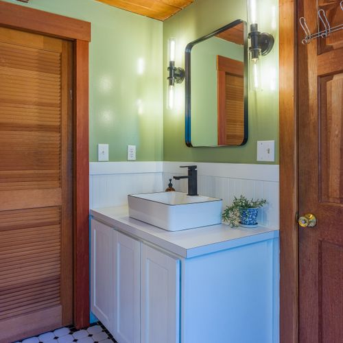 Downstairs full bath connects to the living room, as well as the guest bedroom.