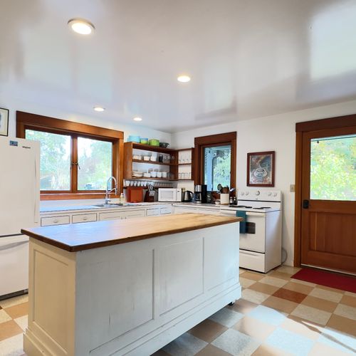 Country kitchen with plenty of counter space and coffee bar.