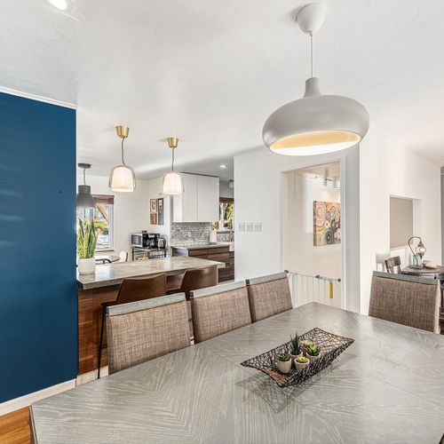 Spacious dining area seamlessly opens to the kitchen, creating the perfect space for meals and entertaining.