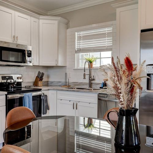 Modern kitchen w/ stainless steel appliances & generous counter space.