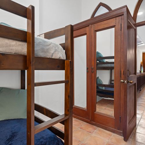 An inviting guest room featuring distinctive bunk beds, perfectly combining functionality with modern style.