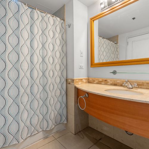 A pristine and functional bathroom awaits, offering a combination shower and tub. Tasteful design ensures a comfortable experience.