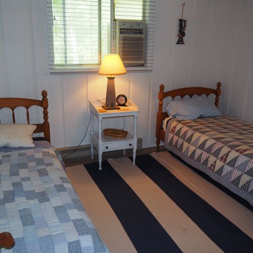 Bedroom #2 (main floor):  features 2 twin beds, dresser, nightstand, and closet.