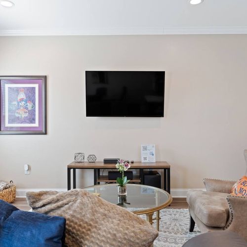 Living room w/ wall-mounted TV — perfect for a quiet evening in.