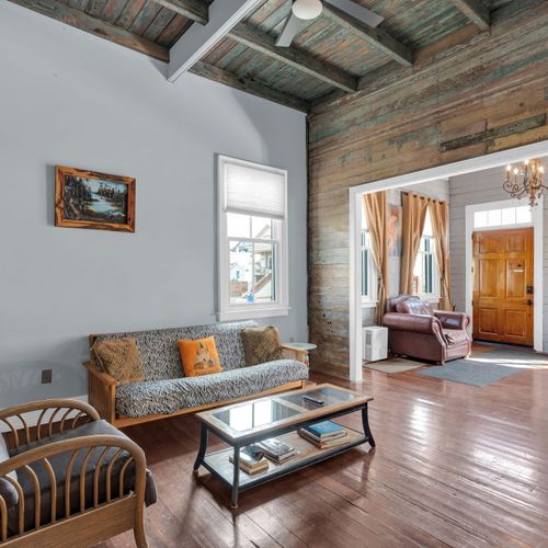 Bright, open living area flooded w/ natural light & warm wood floors.