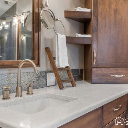 The master bath includes elegant touches like a spacious walk-in shower, a separate seated vanity area, premium fixtures, and ample storage