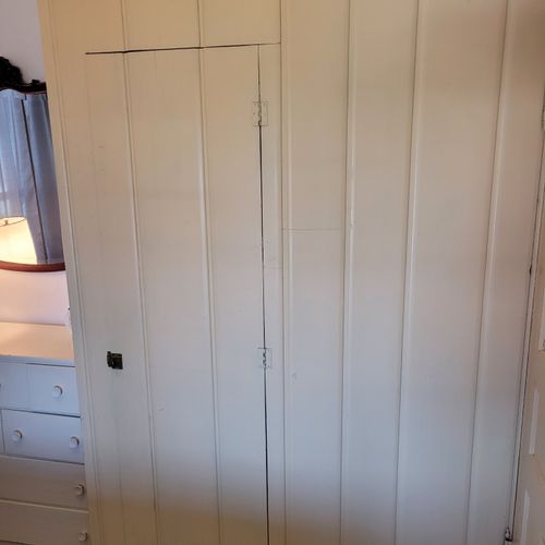 BEDROOM #2 (MAIN FLOOR):  Features a full-size bed, nightstand, chair, dresser, mirror, and closet.