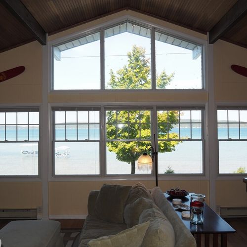 Upstairs living room:  the home has a beautiful living room with comfy furniture, a television with live streaming via roku, a ceiling fan, and spectacular views of crystal lake. (note that the fireplace is not for guest usage. )
