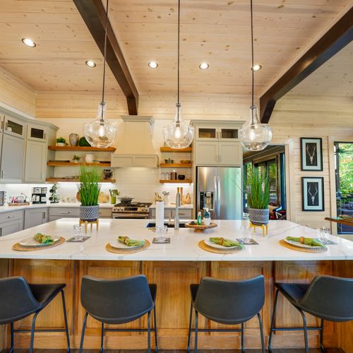 The giant island with bar seating for 4 is the heart of the kitchen—warm, bright, and designed for sharing life’s best moments.