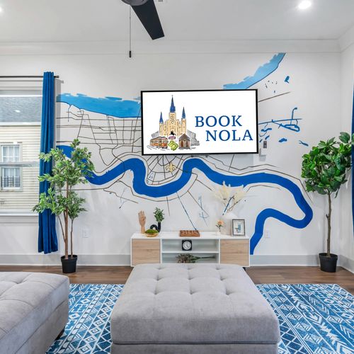 Living room adorned w/ a colorful NOLA map mural that sets the local vibe.