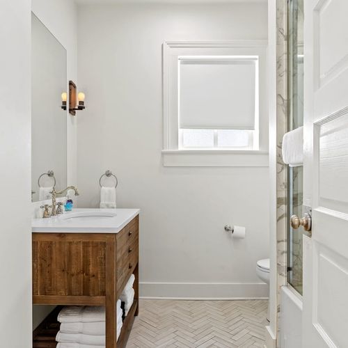 First bathroom w/ a spacious shower & large mirror.