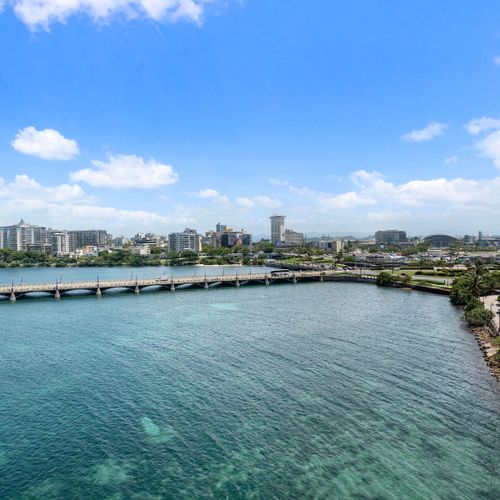 Expansive panoramic views of the glistening Condado Lagoon and city skyline.