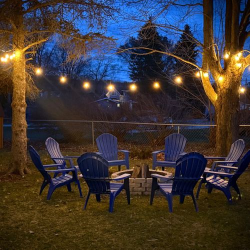 Exterior:  the backyard bonfire ring lit up at night