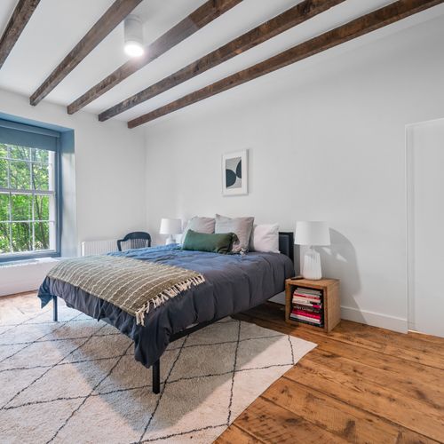 Cluttered mind? Leave it at the door. This sleek bedroom is the perfect place to refocus and refresh.