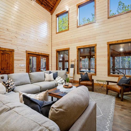This cozy gathering space has large windows to frame the picturesque views.